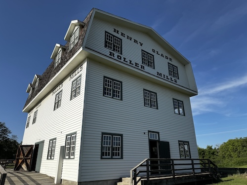 Three story building with signs saying Henry Glade Roller Mills.