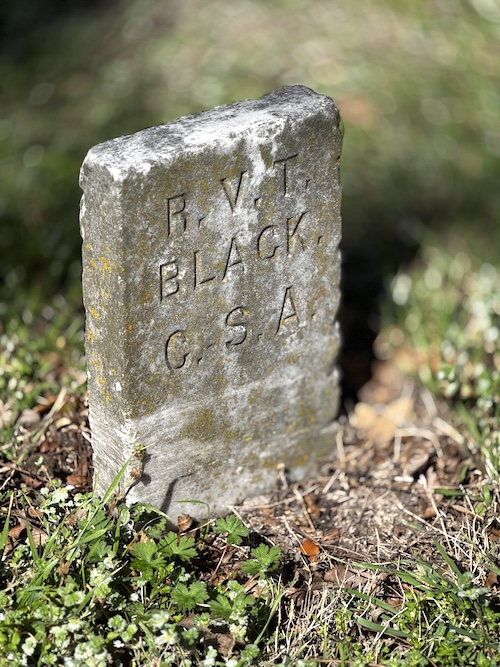 Image of simple upright headstone of Confederate Veteran, saying P.V.T. Black. C.S.A.