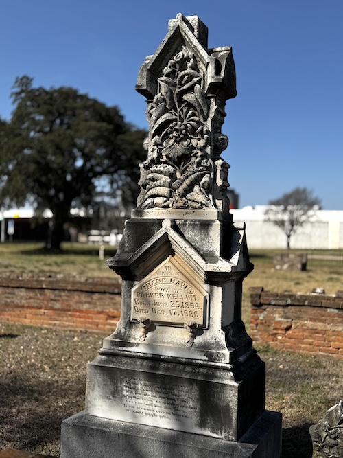 Image of tall, ornate headstone with intricate carving on the top 1/3.